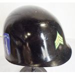 Vietnam era helmet liner that has been painted black with the Infantry School decals on both sides and Sergeant rank on the front