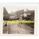 1950's era photograph of a Photographer in front of a Corsair