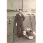 WWII Japanese Navy Sailor Standing next to a life ring on a ship Photo